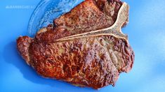 a piece of meat sitting on top of a blue plate