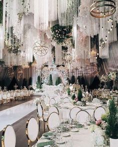 an elaborately decorated banquet hall with chandeliers and tables set up for a formal function