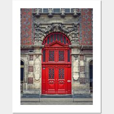 an old building with a red door and ornate carvings on the front, framed in white paper