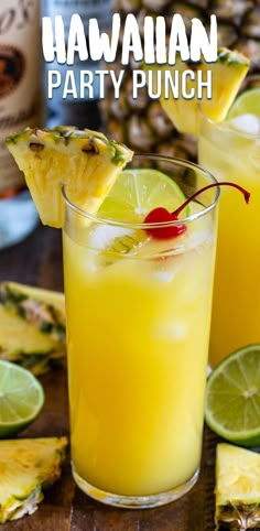 two glasses filled with pineapple punch and garnished with cherries