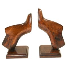 a pair of wooden bookends made to look like they have hands on them