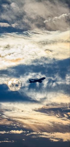 an airplane is flying through the cloudy sky