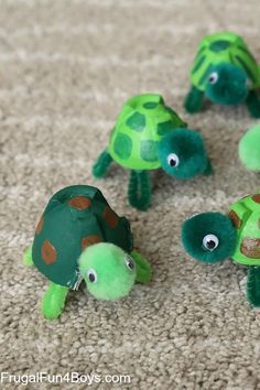 four little turtles made out of paper on the floor