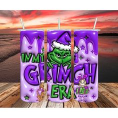 three purple candles with the words my grinch era written on them in front of a sunset