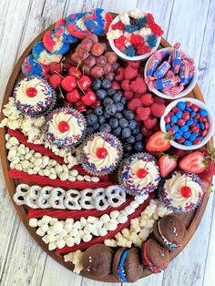 an american flag dessert platter with cupcakes and berries