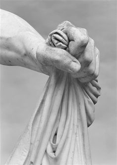 hands holding each other in the middle of a sculpture