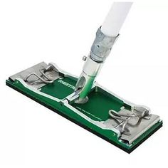 a green and white mop on top of a green floor with the handle extended