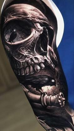 a man with a skull tattoo on his arm