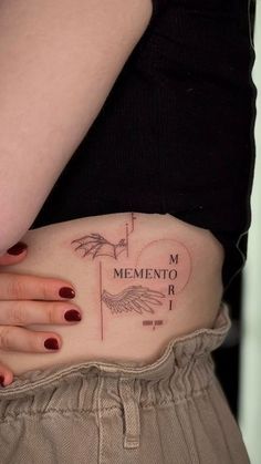 a woman's stomach with a tattoo on it that reads, mementoo rio