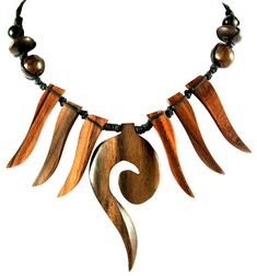 a necklace with wood and beads hanging from it