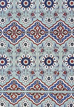 an ornate tile pattern with blue, red and white designs on the outside of it