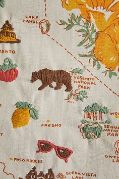 a close up of a piece of cloth with animals and other things on it,