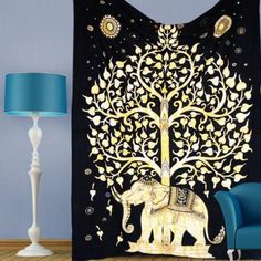 an elephant with a tree on it's back in front of a blue chair