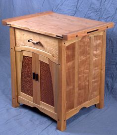 a wooden cabinet with two doors and one drawer