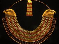 an ancient gold necklace with two birds on it