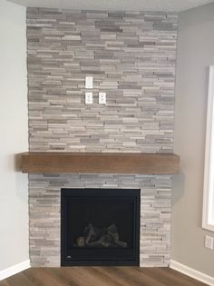 a living room with a fire place and wood flooring in front of the fireplace