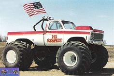 an old red and white truck with a flag on top