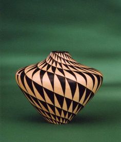 a black and white vase sitting on top of a table