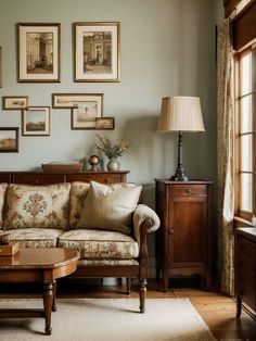 a living room filled with furniture and pictures on the wall above it's coffee table