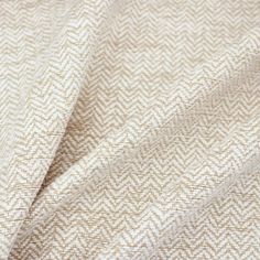 the fabric is beige and white with small herrings on it's sides, which are