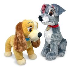 the lady and the tramp stuffed animals are next to each other on a white background