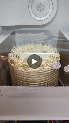 a cake with white frosting in a box