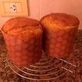 two muffins sitting on top of a wire rack in front of a wall