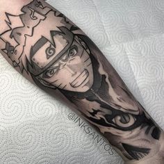 a man's arm with an anime character tattoo on it