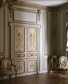 an ornate room with white walls and gold trim