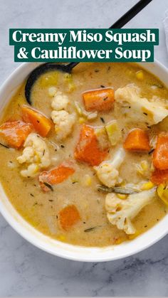 a bowl of soup with carrots, cauliflower and other items in it