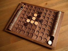 a wooden board game with several pieces in it