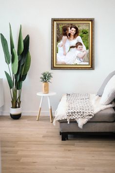 a living room filled with furniture and a painting hanging on the wall over a couch