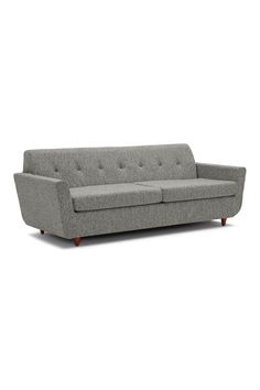 a gray couch sitting on top of a white floor