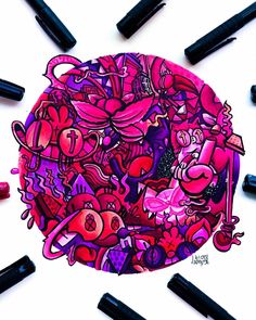 a drawing of pink and purple doodles on a white surface surrounded by black crayons