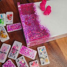 there are many dices on the table with pink and purple sprinkles