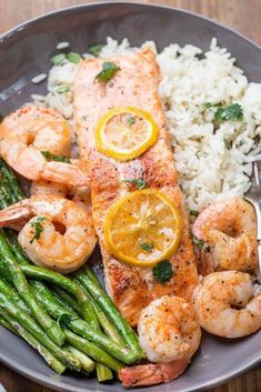 a plate topped with shrimp, asparagus and rice