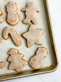 iced cookies with icing on a baking sheet