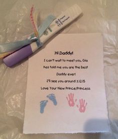 a baby's hand and foot prints on a sheet of paper next to a toothbrush