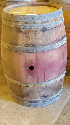 an old wooden barrel sitting on the ground