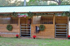 a horse stable with christmas decorations on the windows