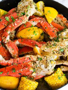 cooked crab legs and corn in a skillet