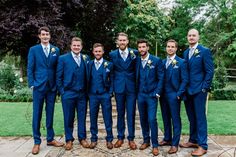 a group of men in blue suits standing next to each other