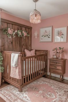 a baby's room is decorated in pink and white with flowers on the wall