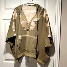 So Much Detail! Can Fit Up To An Xl. Has A Hoodie, And Front Pocket. Side Buttons Do Open. Green Camo Print. Oversize Fit. Never Worn, Just Clearing Out My Closet. Came From A Boutique. Pet And Smoke Free Home. Any Questions, Just Ask. Khaki Military Tops With Patch Pockets, Military Style Long Sleeve Patchwork Outerwear, Poncho Style Top, Military Style Camouflage Cotton Shirt, Camouflage Military Hooded Long Sleeve Jacket, Military Camouflage Tops With Pockets, Poncho Style, Green Camo, Camo Print