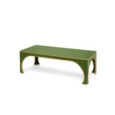 a green coffee table with gold trimmings on the legs and bottom, in front of a white background