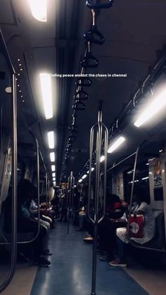 the inside of a subway car with people sitting on it