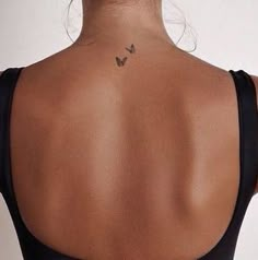 a woman with a butterfly tattoo on her back