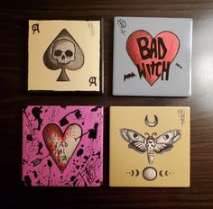 four cards with different designs on them sitting on a table