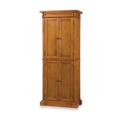 a tall wooden cabinet sitting on top of a white wall