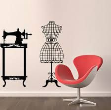 a room with a chair, sewing machine and wall decals